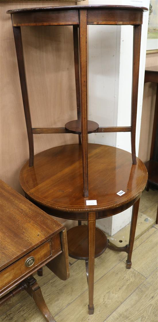 An Edwardian inlaid mahogany circular topped two tier occasional table, on square tapered legs W.61cm and 54cm